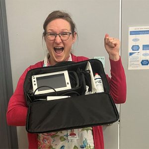 nurse shown with a bladder scanner